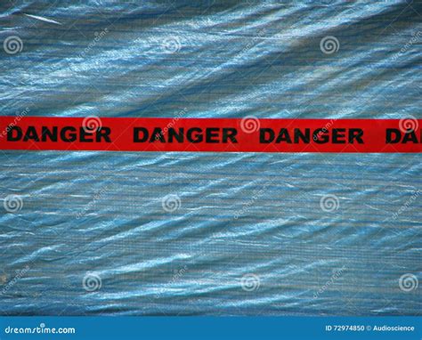 Red Danger Tape Over a Blue Wall Background Stock Photo - Image of line ...