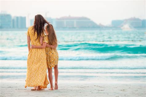 Beautiful Mother And Daughter At The Beach Enjoying Summer Vacation