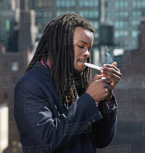 African Man Smoking Hand Rolled Cigarette Stock Photo Dissolve