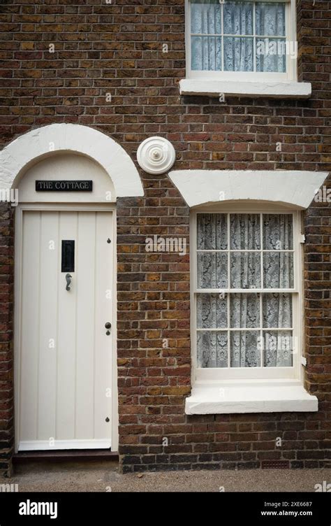 Traditional British Village Houses Exteriors With Closed White Door And