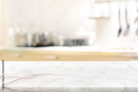 Marble stone table top (kitchen island) on blur kitchen interior ...