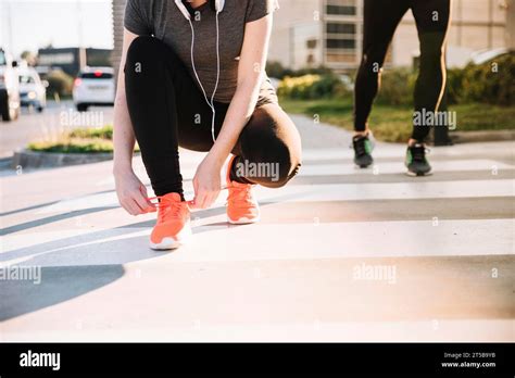 Crop Woman Tying Laces Training Stock Photo Alamy