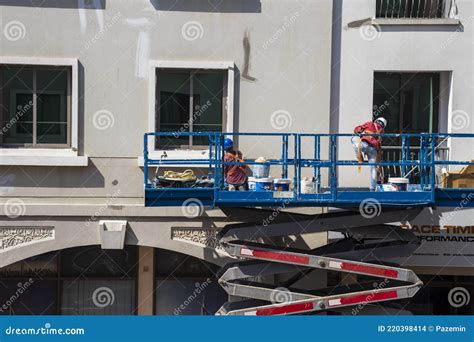 Shot Of A Maintenance Workers Working At Heights Repairing Facade Of