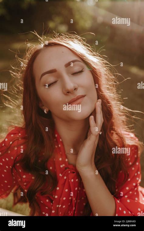 Portrait Of Pretty Redhead Woman Outdoor In Sunset Light Female Model Touching Her Face By Hand