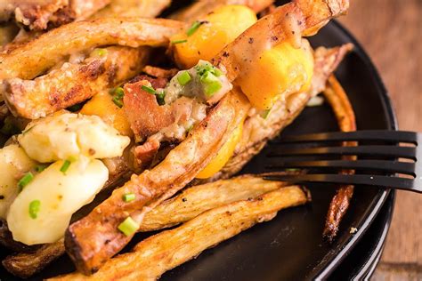 Canadian Poutine Smothered Fries With Cheese Curds Bacon And Gravy