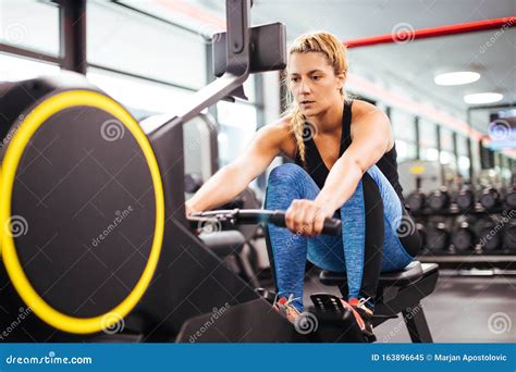 Young Sporty Woman Working Out On A Rowing Machine Stock Image Image