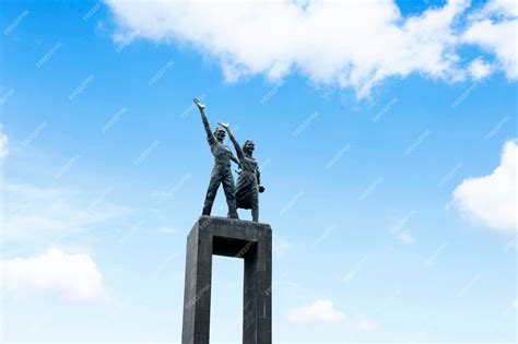 Premium Photo | Low angle view of Welcome statue with blue sky