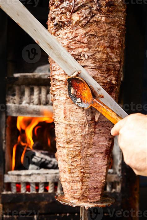 Doner Meat Being Sliced From Rotating Spit Stock Photo At Vecteezy