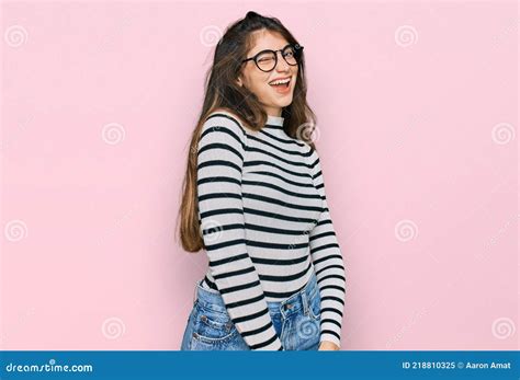 Young Beautiful Teen Girl Wearing Casual Clothes And Glasses Winking