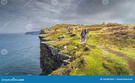 Group of Tourists Hiking and Sightseeing Iconic Cliffs of Moher ...