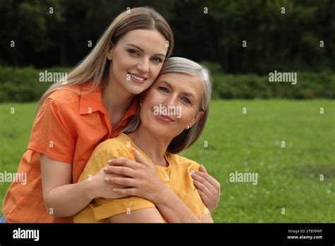 Happy Mature Mother And Her Daughter Hugging In Park Stock Photo Alamy