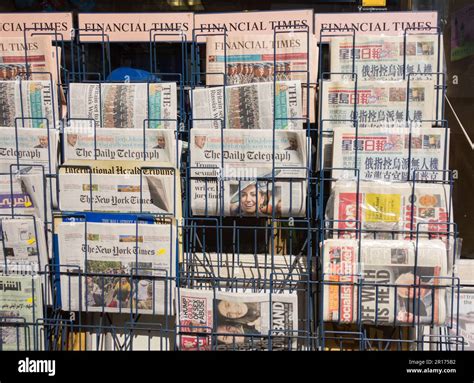 International And Uk Newspaper Front Pages Outside A Newsagents In