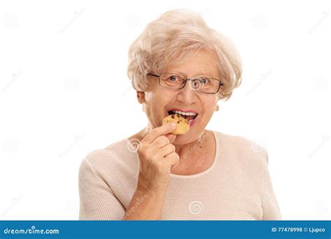 Senior Woman Eating A Cookie Stock Photo Image Of Elderly Caucasian