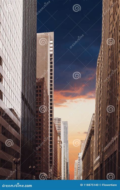 A Tall Building That Goes Into Sunset Sky And Rainy Clouds The Sky