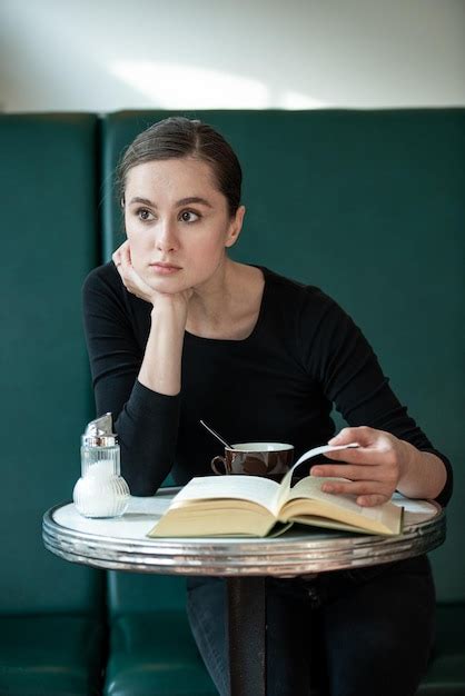 Premium Photo Thoughtful Woman Sitting At Table In Cafe