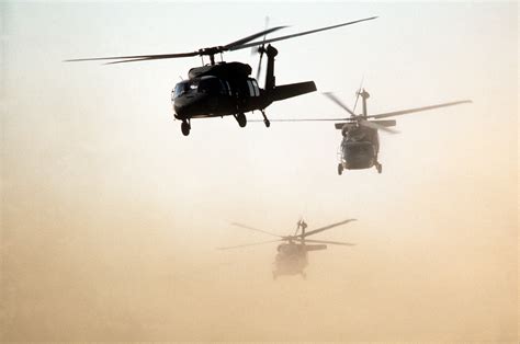 U.S. Army UH-60 Black Hawk helicopters fly an air assault training ...