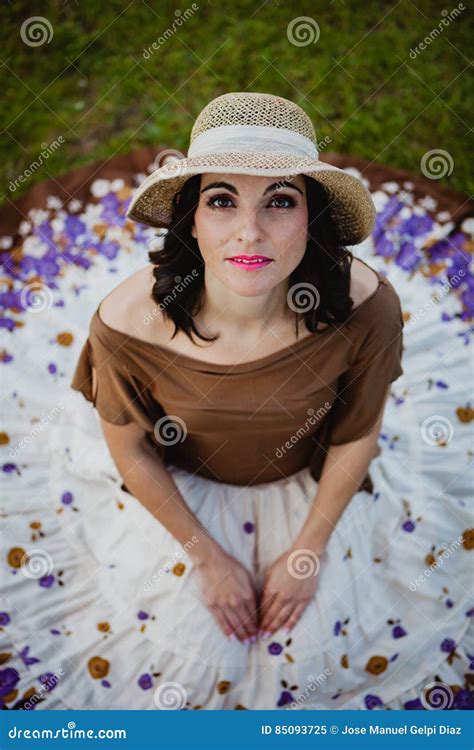 Pretty Brunette Woman Sitting With A Flowered Skirt View From A Stock Image Image Of Field