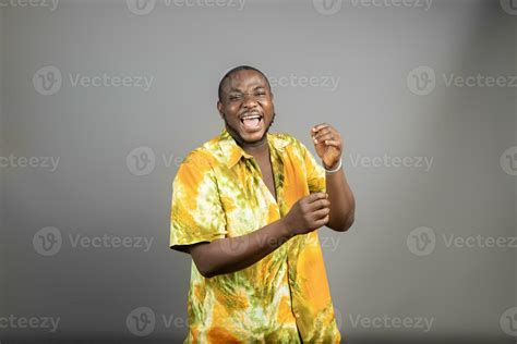 Overexcited Young Black Guy Raising Fist Up On White Background