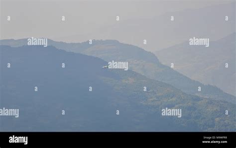 Mountain scenery with an aircraft flying in the sky Stock Photo - Alamy