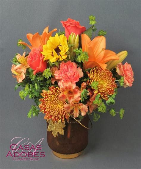 a vase filled with lots of different colored flowers