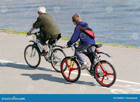 Father And Son Are Riding On Mountain Bicycles Stock Image Image Of