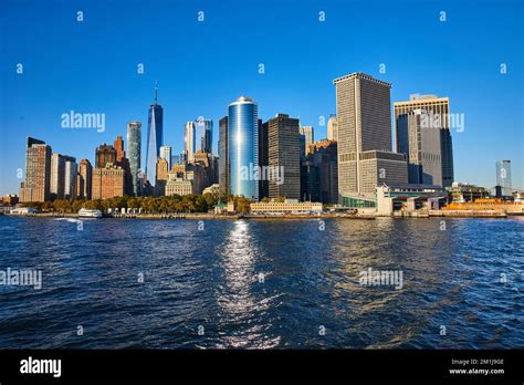 Stunning New York City skyline from boat with sun shining over skyscrapers Stock Photo - Alamy