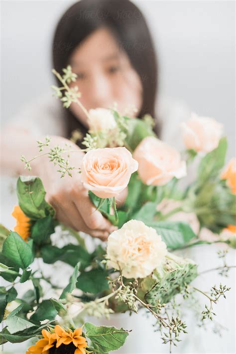 Woman Arranging Flowers By Stocksy Contributor Pansfun Images Stocksy