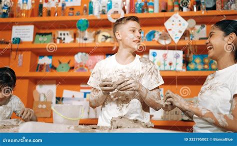 group  diverse children playing clay  wearing muddy shirt