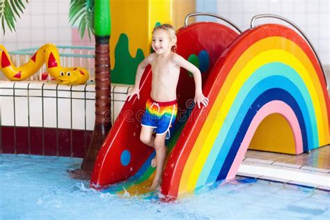 Child on Swimming Pool Slide. Kids Swim. Water Fun Stock Image - Image ...