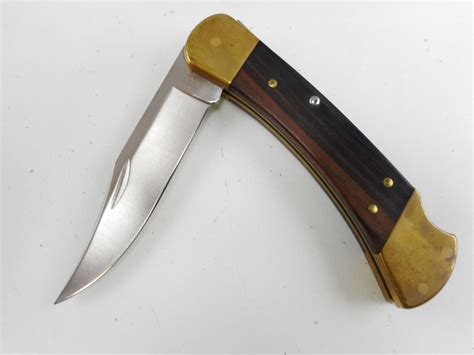 BUCK KNIFE COMMEMORATIVE FOLDING HUNTER KNIFE, IN LEATHER SHEATH