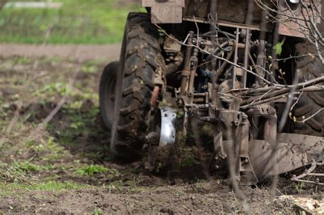 Premium Photo | Farm tractor with plow plows the field and prepares for ...