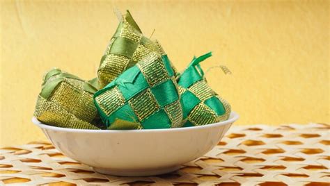 Premium Photo Ketupat Decoration Made From Ribbon Over Yellow Background