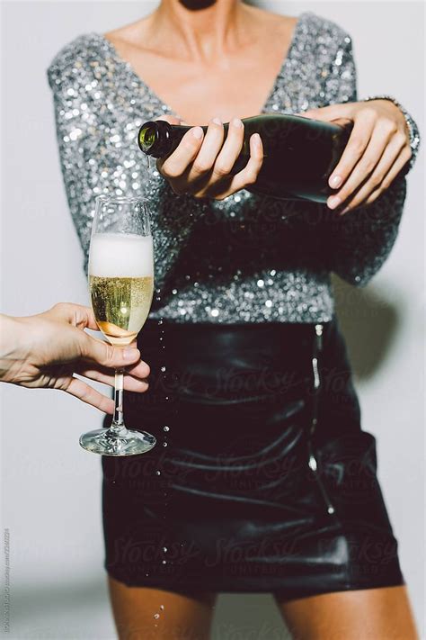 Anonymous Woman Serving A Glass Of Champagne In A New Year Party Celebration By Stocksy