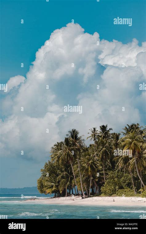 Big clouds on a paradise beach in Indonesia Stock Photo - Alamy
