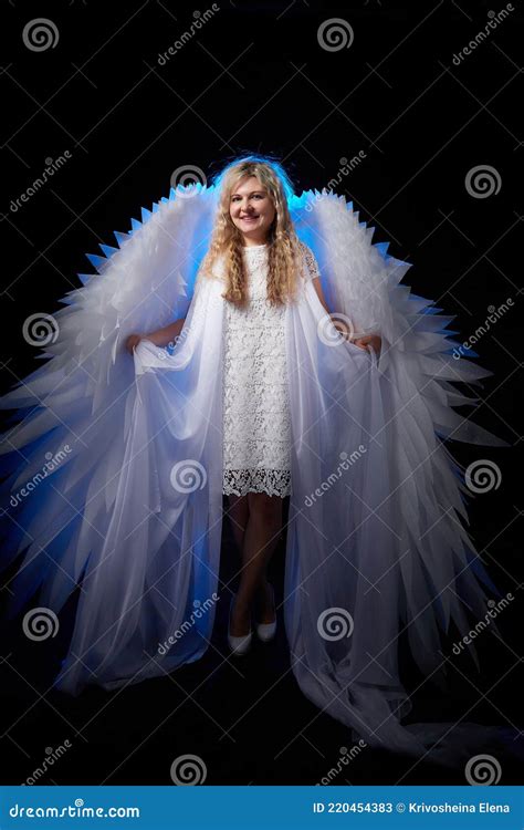 A Beautiful Blonde Girl With Curly Hair And White Wings Looks Like An Nice Angel Stock Image