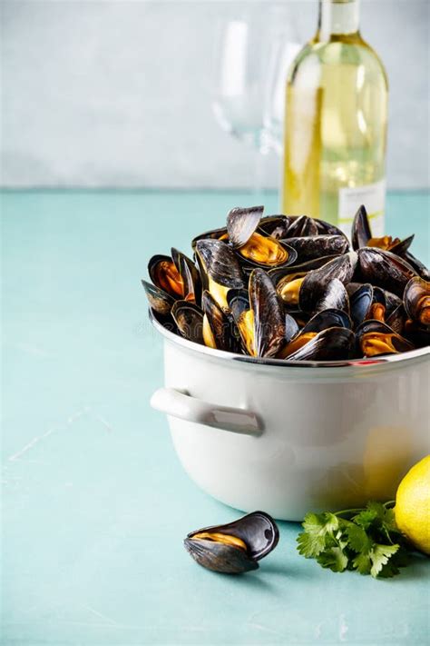 Pot Of Steamed Mussels On Blue Background Stock Photo Image Of