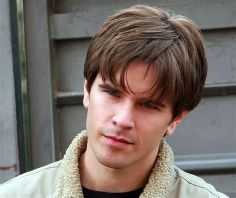 A Close Up Of A Person Wearing A Jacket And Looking At The Camera With A Serious Look On His Face