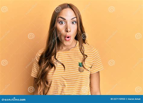 Young Brunette Woman Wearing Casual Clothes Scared And Amazed With Open