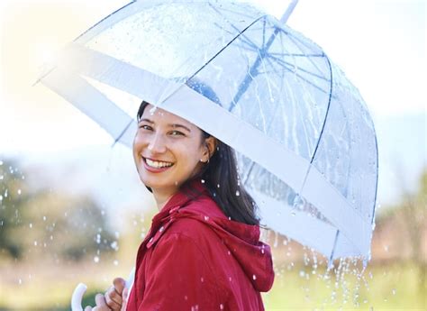 Premium Photo My Umbrellas Got Me Covered Shot Of A Young Woman