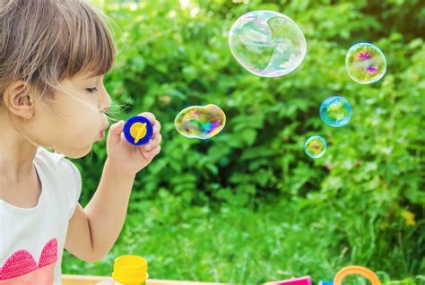 Premium Photo | The children are blowing bubbles. selective focus.