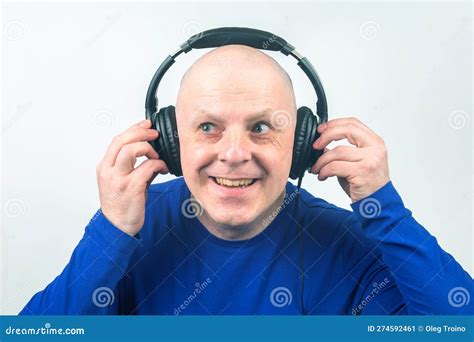 Smiling Man With Headphones And Digital Portable Player In Hand Relaxes