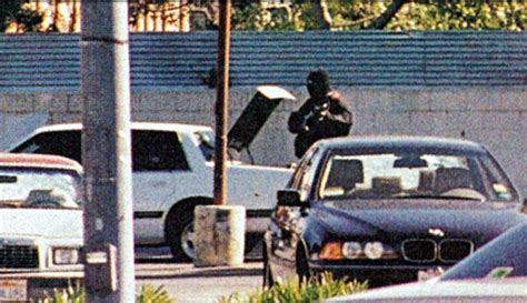 Larry Phillips walks along getaway vehicle as he fires at police after ...