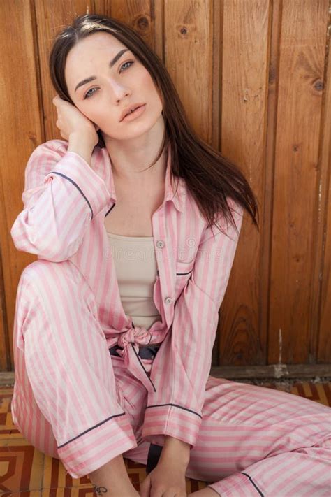Beautiful Brunette Woman In Pink Pajamas Sits On The Floor Stock Photo Image Of Happy Asana