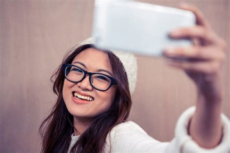 Premium Photo Smiling Asian Woman Wearing Eyeglasses Taking Selfie