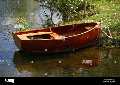 A small wooden row boat is tied to shore Stock Photo: 31323283 - Alamy