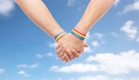 Premium Photo Hands Of Couple With Gay Pride Rainbow Wristbands