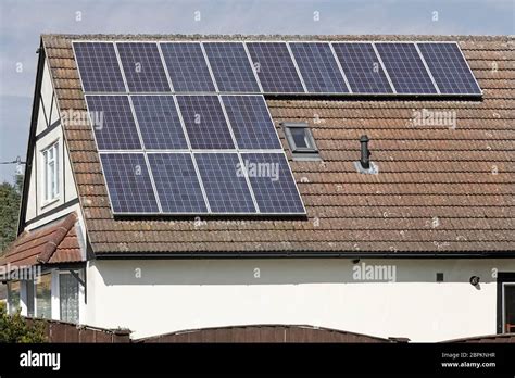 Solar Panels in sunshine installed on south facing roof on sunny blue ...