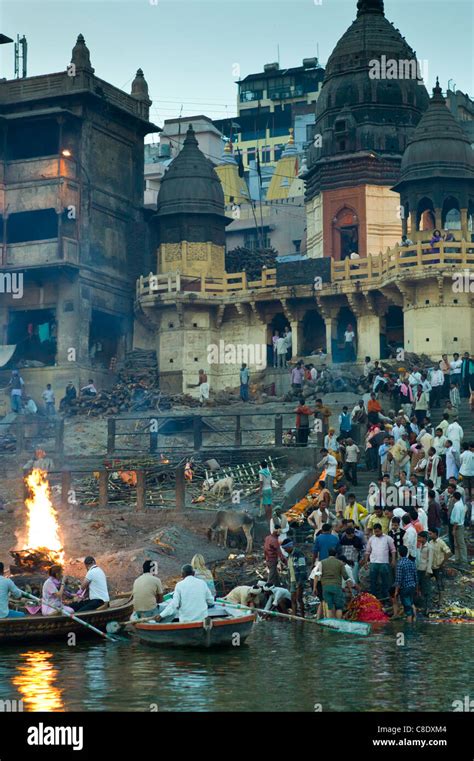 Body Bathed In River Ganges At Hindu Cremation On Funeral Pyre At