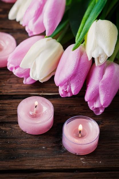 Premium Photo Pink And White Tulips And Candles On The Wooden Table