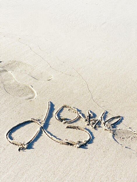 Premium Photo High Angle View Of Text On Sand At Beach